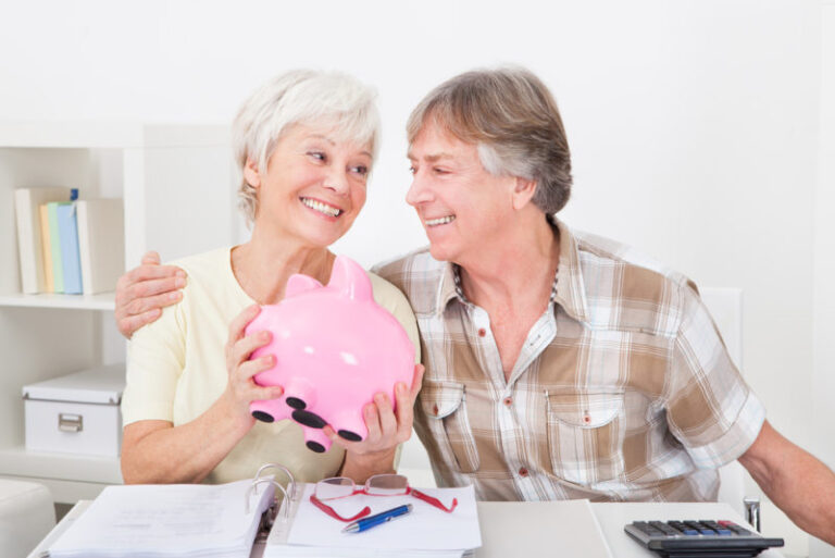 senior couple saving money in piggy bank