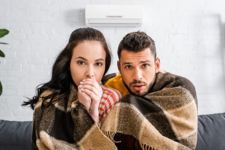 Couple Huddled in Blanket Because of Broken Ductless Heat