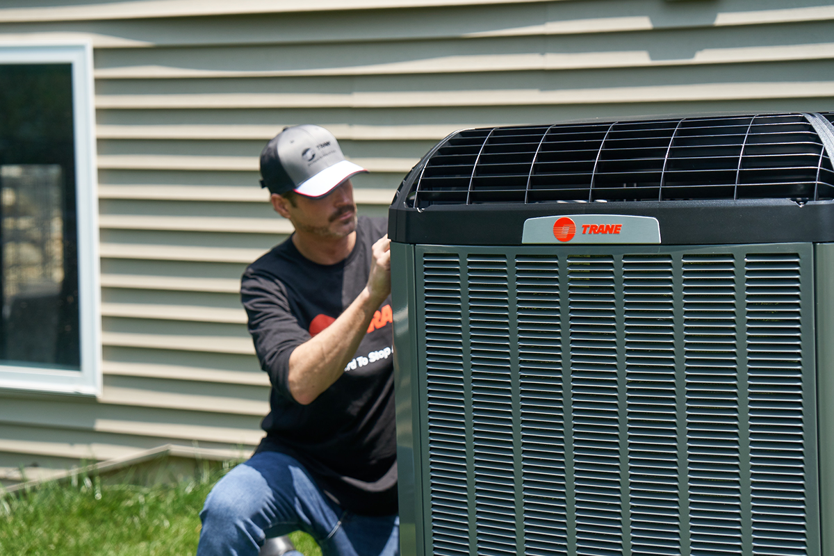 Trane employee working on unit outdoors