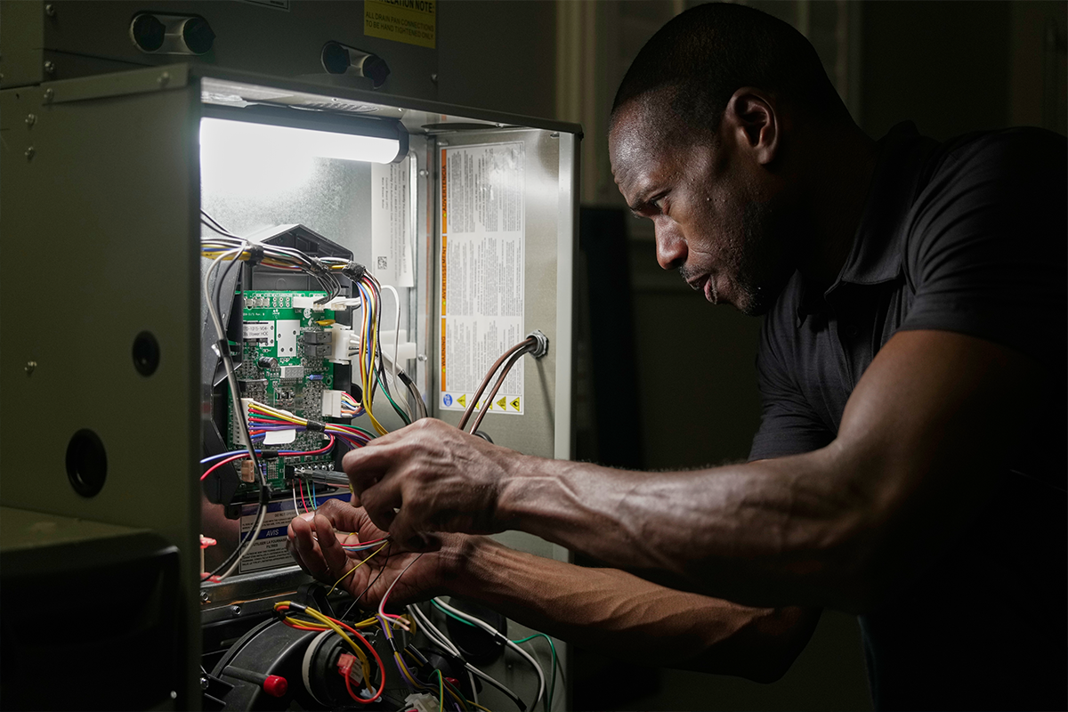 Trane rep repairing heating unit